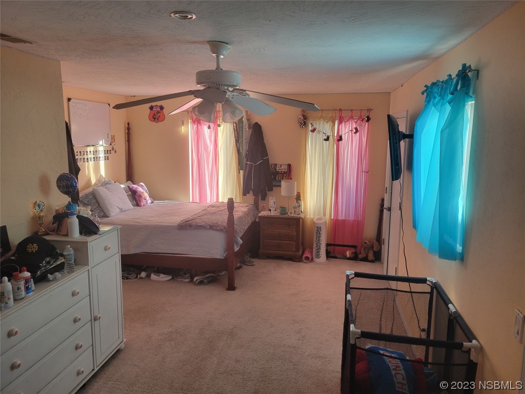 1012 South Riverside Drive Edgewater, FL 32132 - Photo 30 of 31 a bedroom with a bed dresser and a window