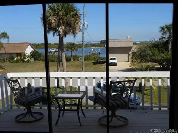 a view of chairs and table in patio