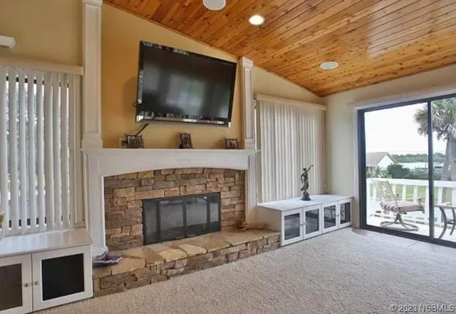 a living room with fireplace furniture and a flat screen tv