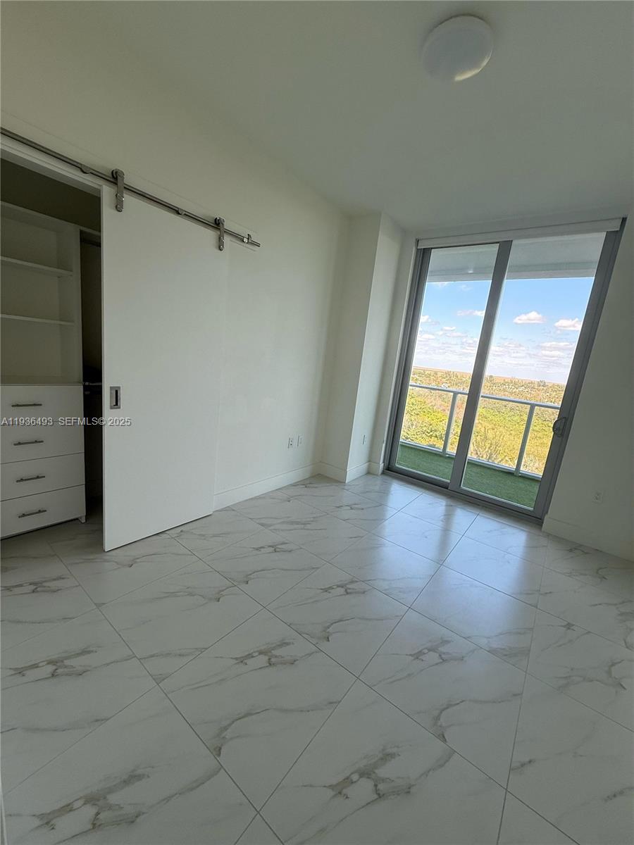 2000 Metropica Way, Unit 901 Sunrise, FL 33323 - Photo 19 of 19 a view of an empty room and window