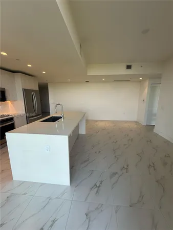a view of kitchen with stainless steel appliances cabinets