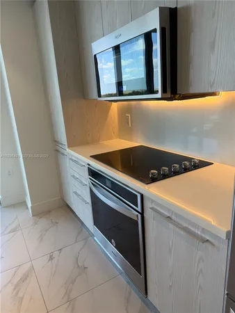 a kitchen with a stove and a microwave