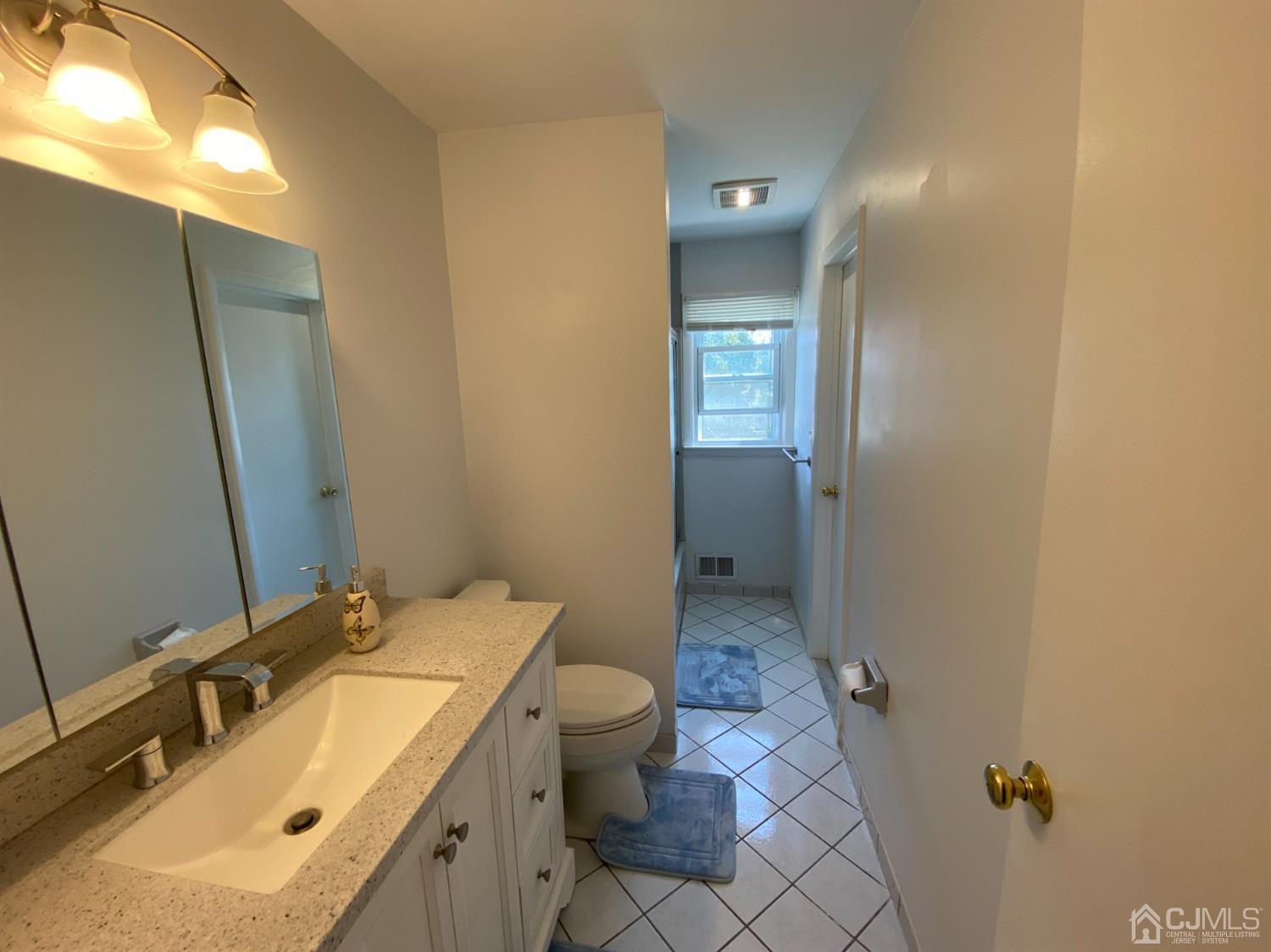 6 Moryan Road Edison, NJ 08817 - Photo 14 of 29 a bathroom with a sink and mirror with toilet