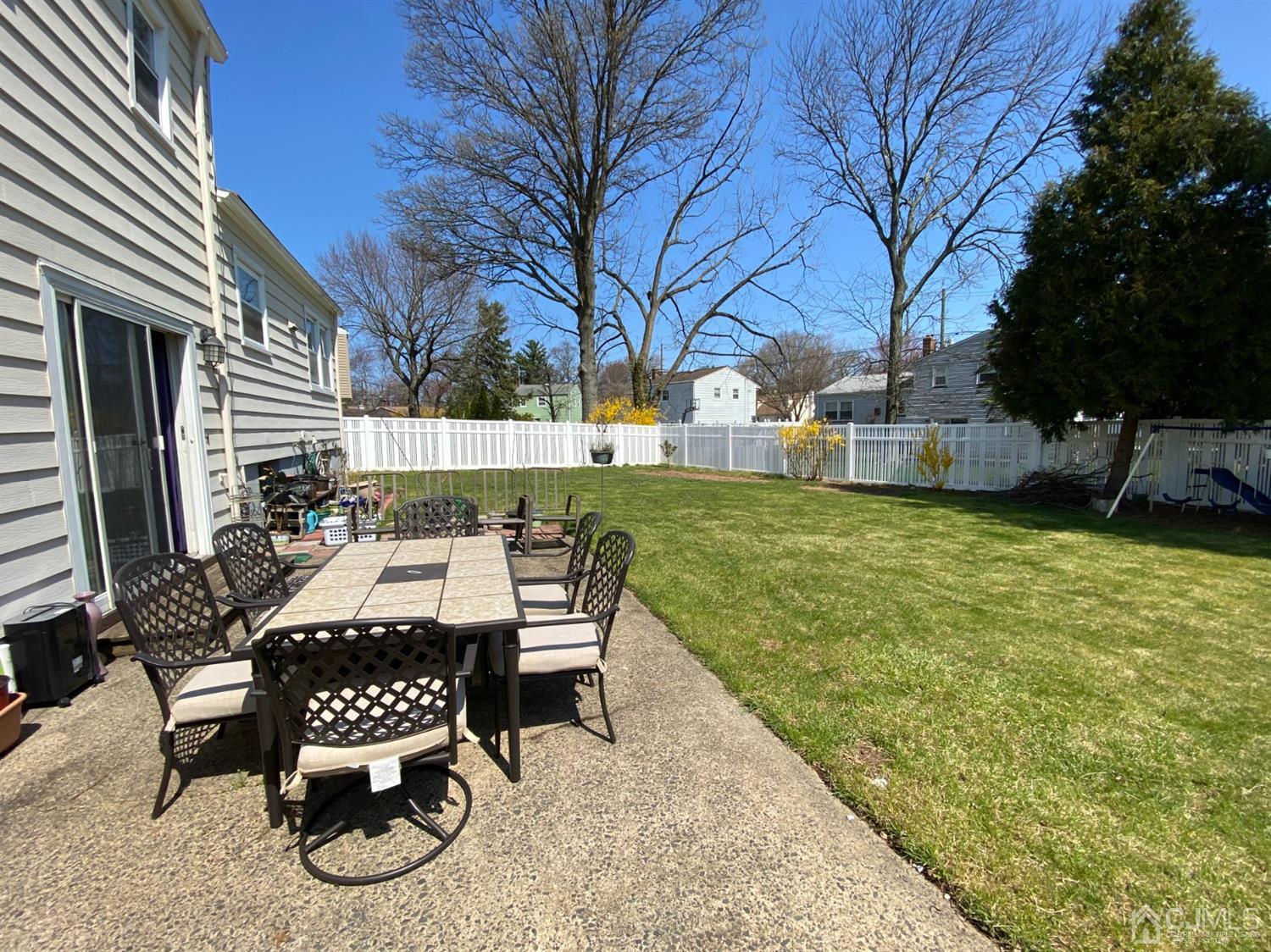 6 Moryan Road Edison, NJ 08817 - Photo 29 of 29 a view of a patio with table and chairs and potted plants with wooden floor and fence
