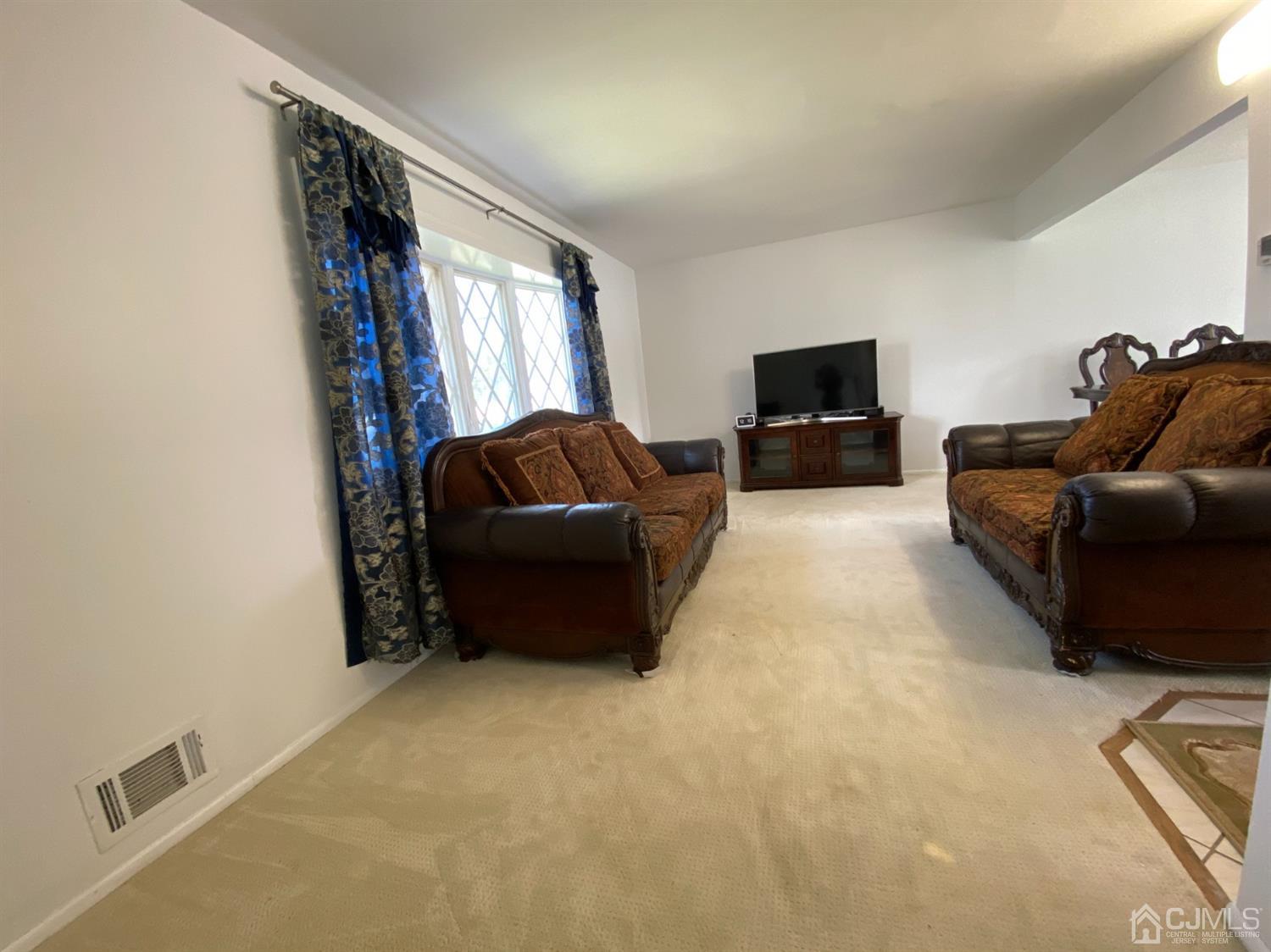 6 Moryan Road Edison, NJ 08817 - Photo 7 of 29 a living room with furniture and a flat screen tv