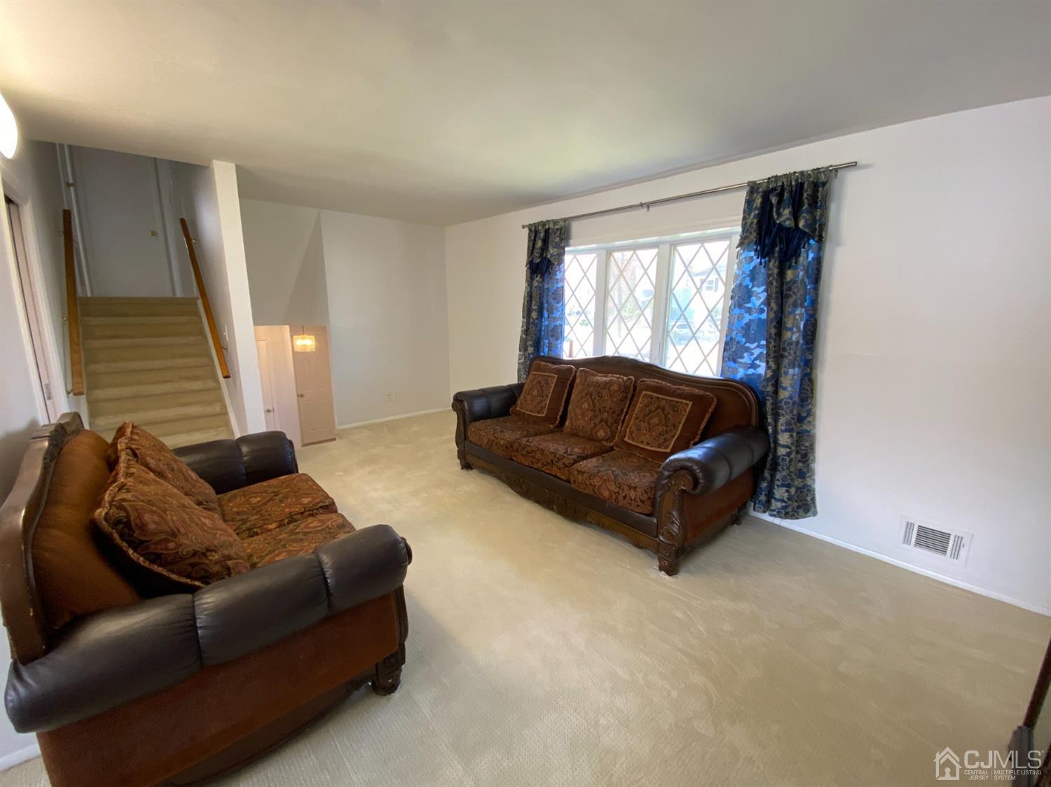 6 Moryan Road Edison, NJ 08817 - Photo 8 of 29 a living room with a couch and a large window