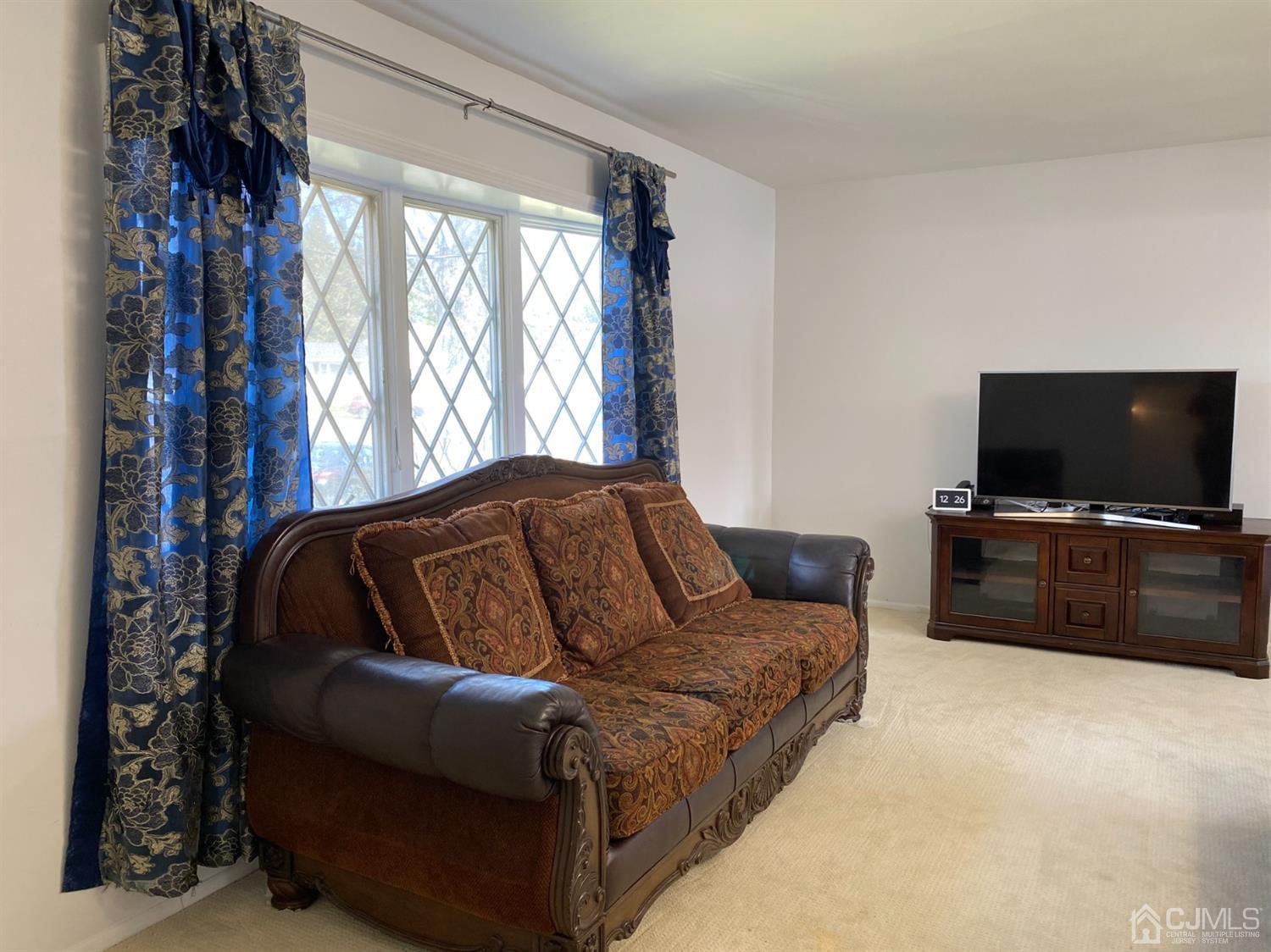 6 Moryan Road Edison, NJ 08817 - Photo 9 of 29 a living room with furniture and a flat screen tv