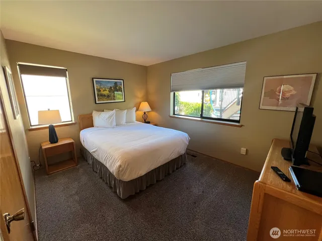 a bathroom with a sink a toilet and a large mirror
