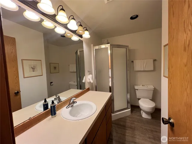 a bathroom with a sink a toilet and a mirror