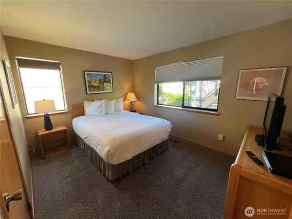 a bathroom with a sink a toilet and a large mirror