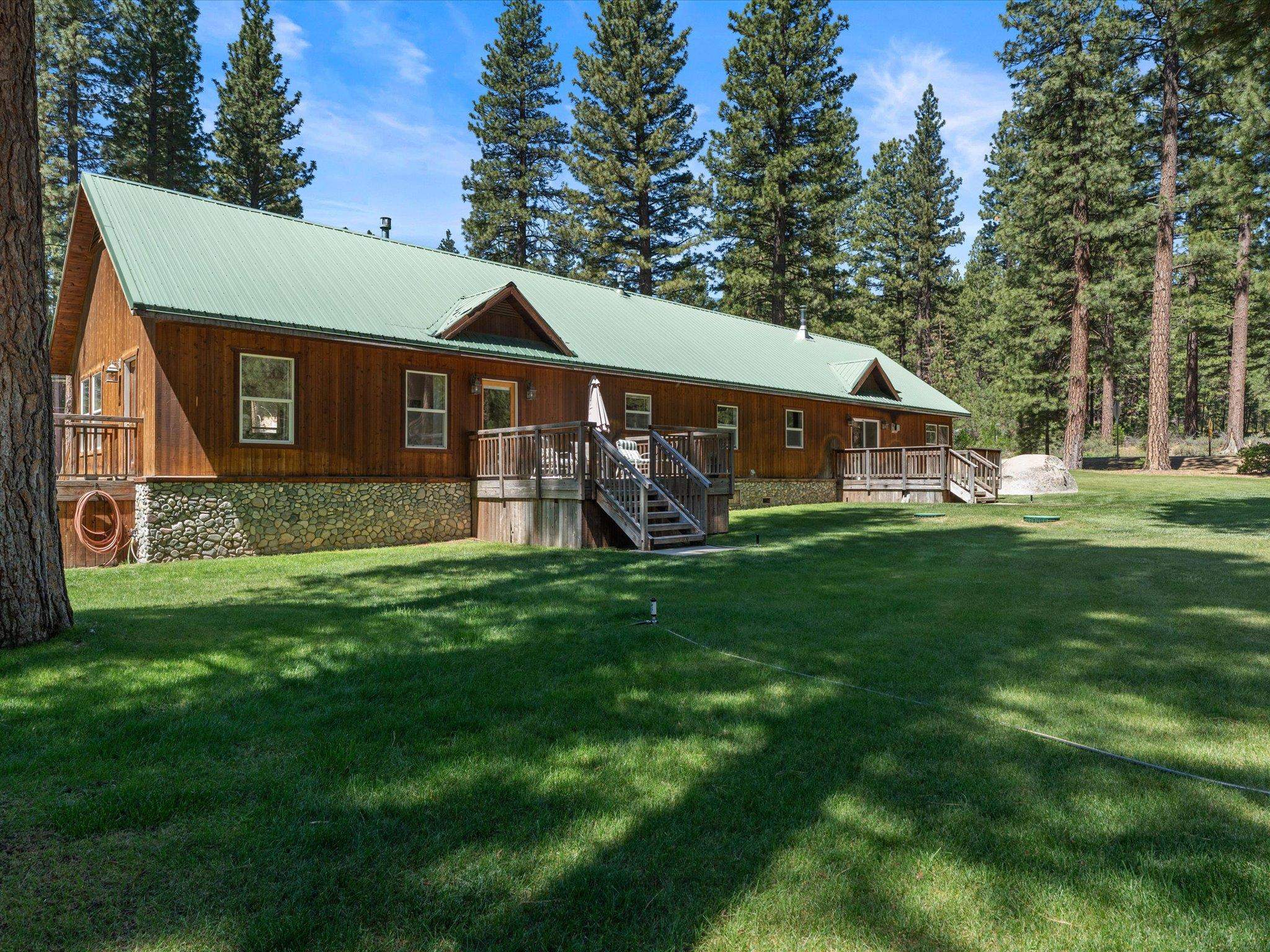97 Main Street Calpine, CA 96124 - Photo 4 of 43 a view of a house next to a big yard and large trees