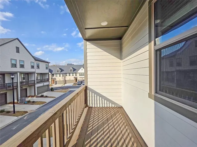 a view of a balcony with wooden floor