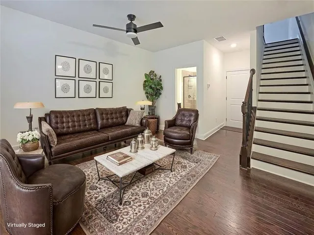 a living room with furniture and wooden floor