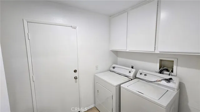 a view of storage and utility room with washer and dryer