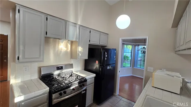a kitchen with stainless steel appliances granite countertop a stove and a refrigerator
