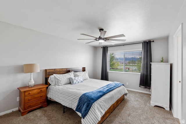 444 South Saddle Road Grantsville, UT 84029 - Photo 11 of 33 Bedroom featuring carpet floors and a ceiling fan