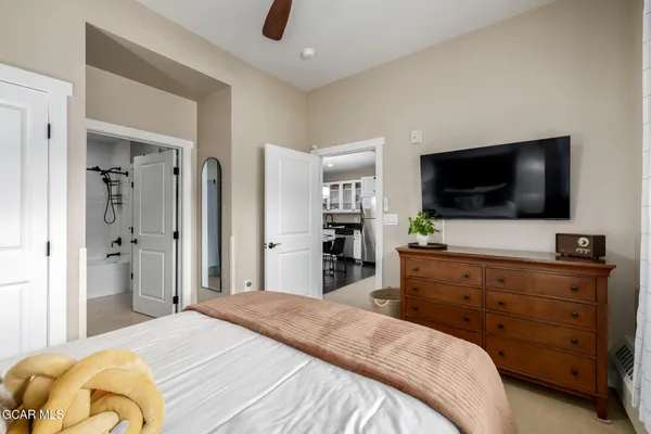 a bedroom with a bed and a flat screen tv