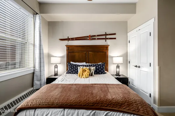 a bedroom with a bed and window