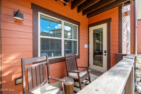 a view of a patio with table and chairs and wooden floor