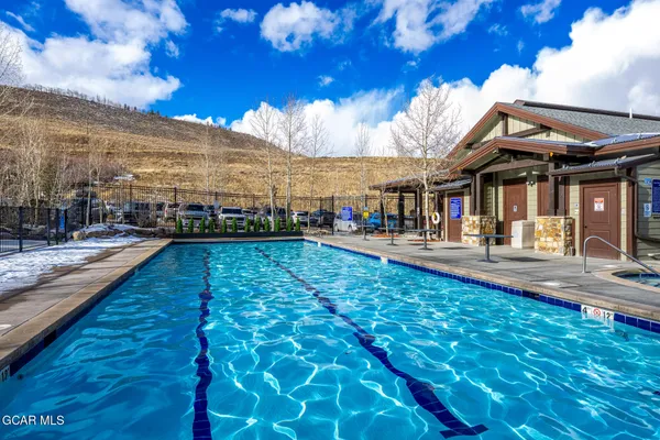 a view of a swimming pool with an outdoor seating