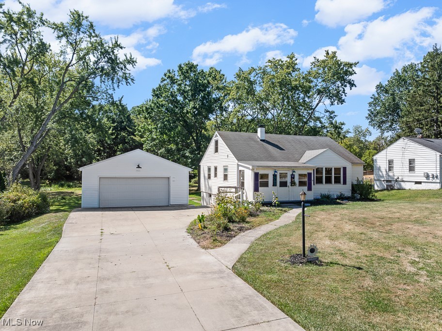 1702 Far View Road Akron, OH 44312 - Photo 36 of 49 View of front facade featuring an outdoor structure, a garage, a front lawn, and a chimney