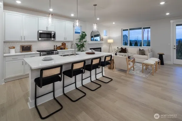 a dining room with furniture and potted plant