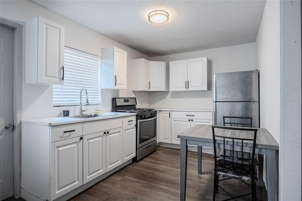 5 North Street Frostproof, FL 33843 - Photo 13 of 22 a kitchen with a sink cabinets and stainless steel appliances