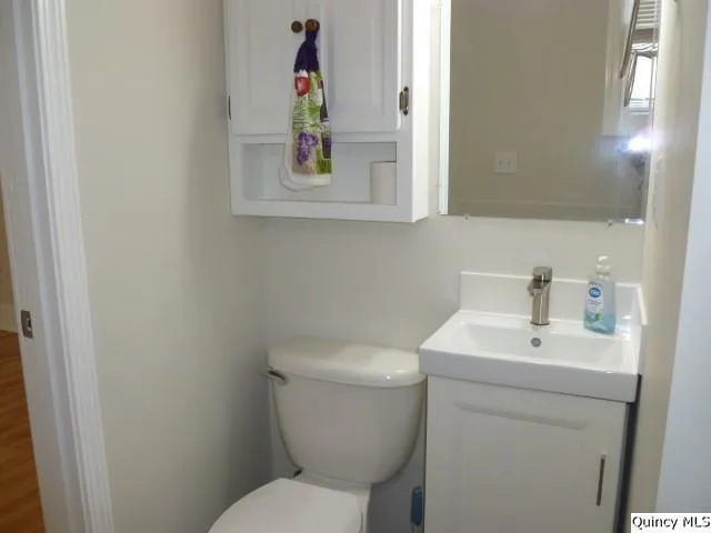 a white toilet sitting next to a bathroom sink