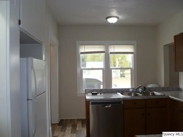 a kitchen with granite countertop a sink and a window