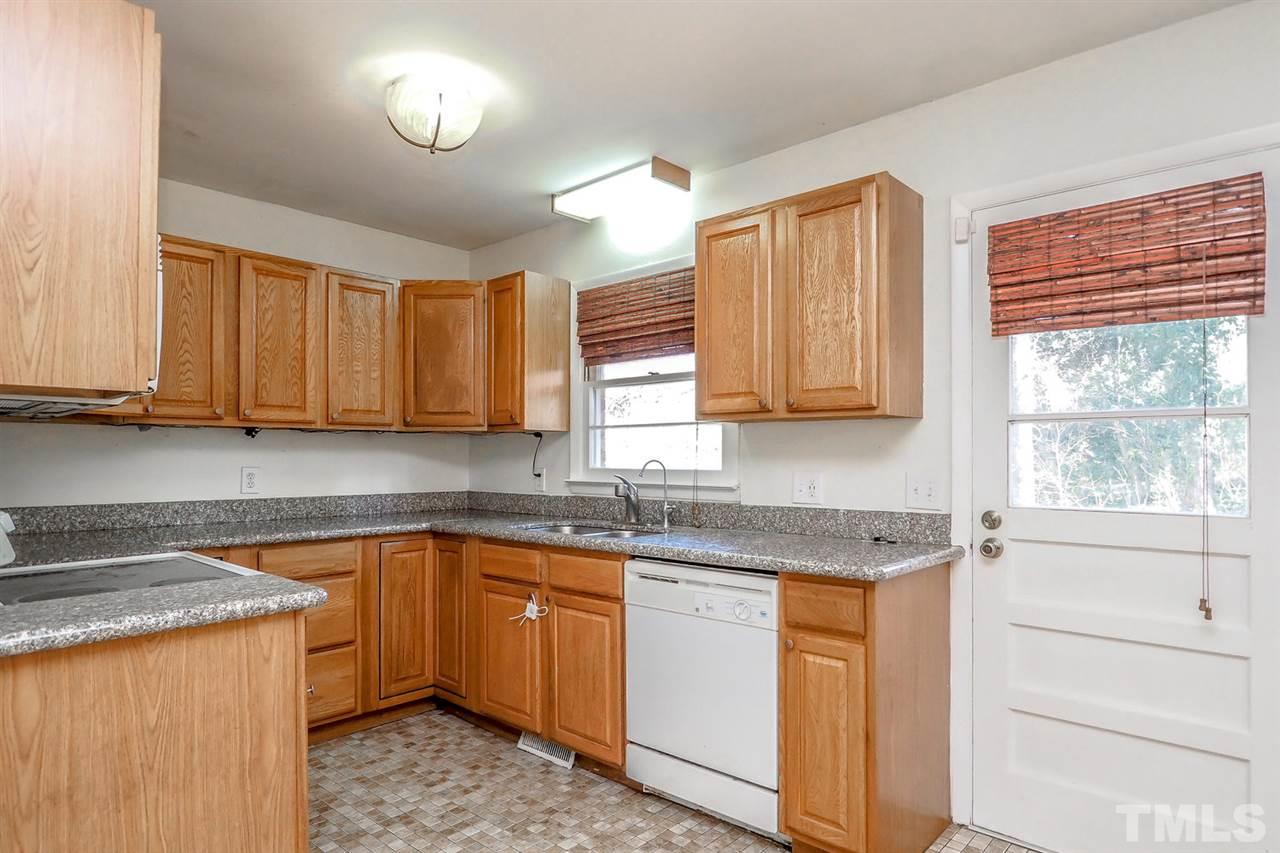 208 Winterlochen Road Raleigh, NC 27603 - Photo 14 of 25 a kitchen with stainless steel appliances granite countertop a sink stove and cabinets