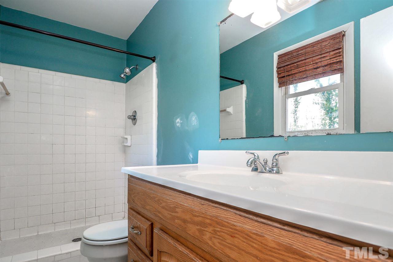 208 Winterlochen Road Raleigh, NC 27603 - Photo 4 of 25 a bathroom with a sink a toilet and shower