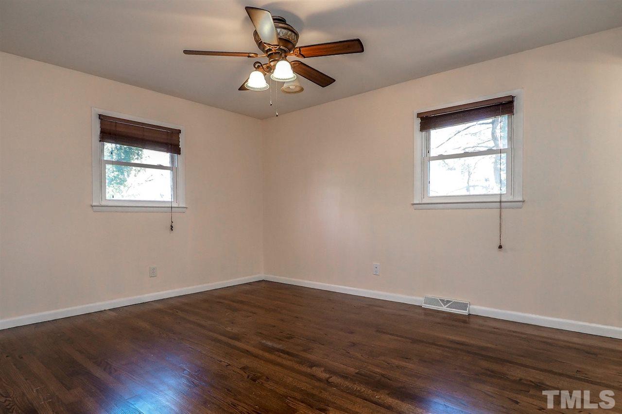 208 Winterlochen Road Raleigh, NC 27603 - Photo 5 of 25 a view of an empty room with wooden floor and a window