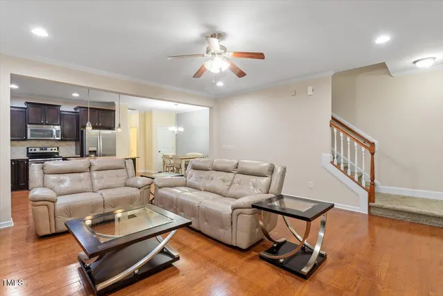 a living room with furniture and a wooden floor