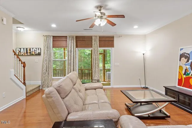 a living room with furniture a window and a flat screen tv
