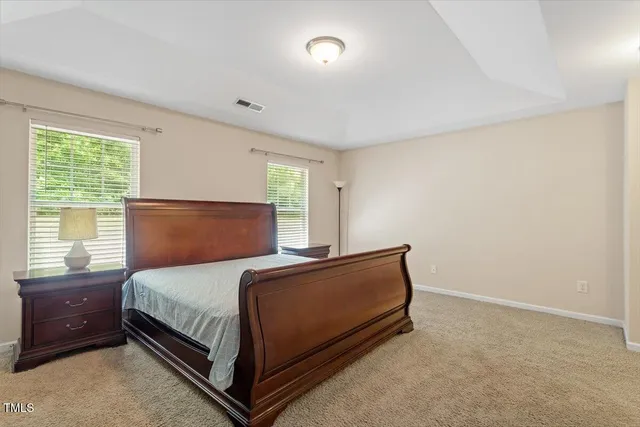 a bedroom with a bed lamp and window