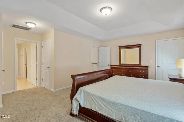 a bedroom with a bed and a night stand