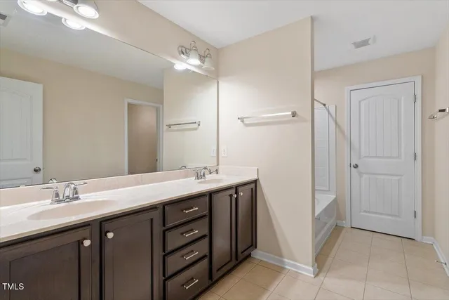 a bathroom with a double vanity sink and mirror