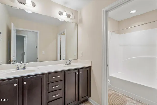 a bedroom with a bed and a chair