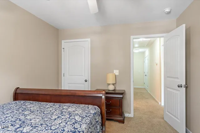 a bed sitting in a bedroom next to a window