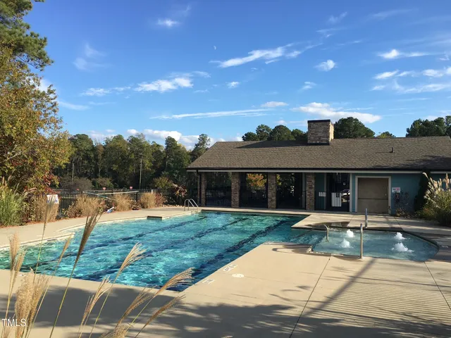 a view of a house with backyard sitting area and lake view