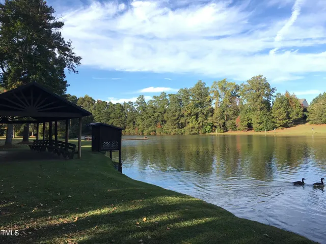 a view of a lake with a house in the background