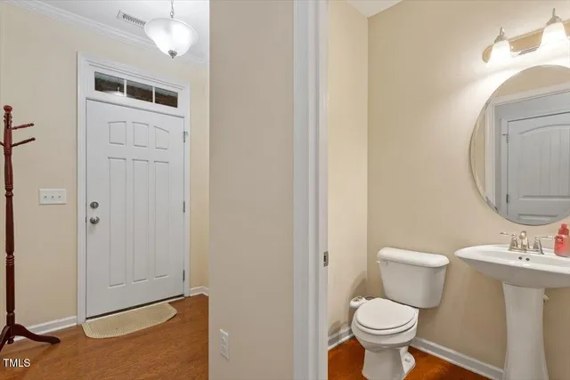a bathroom with a sink toilet and a mirror