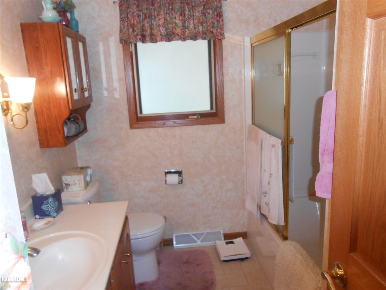 301 East Town Line Road Lena, IL 61048 - Photo 13 of 23 a bathroom with a toilet sink and mirror