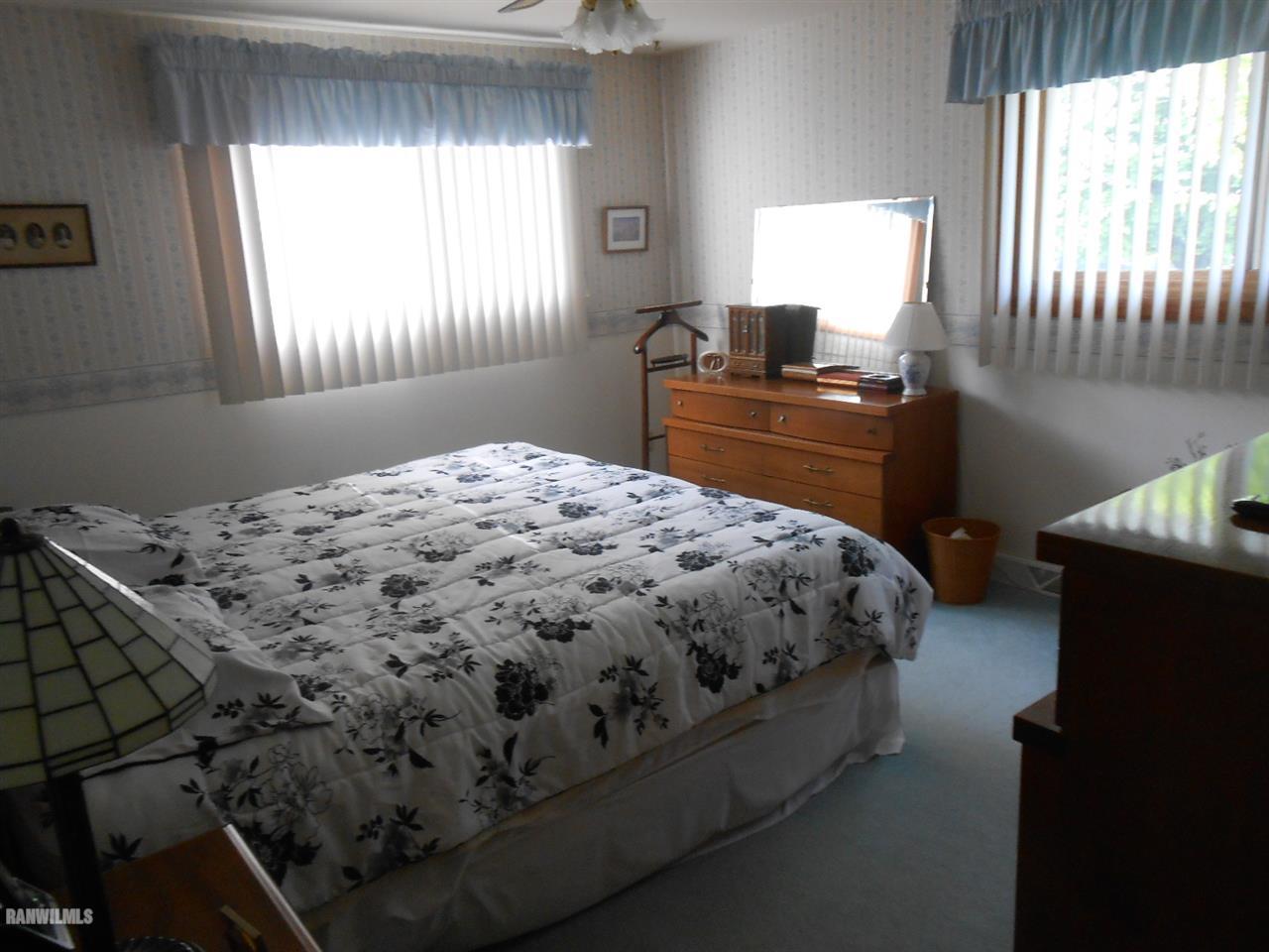 301 East Town Line Road Lena, IL 61048 - Photo 16 of 23 a bed sitting in a bedroom next to a window