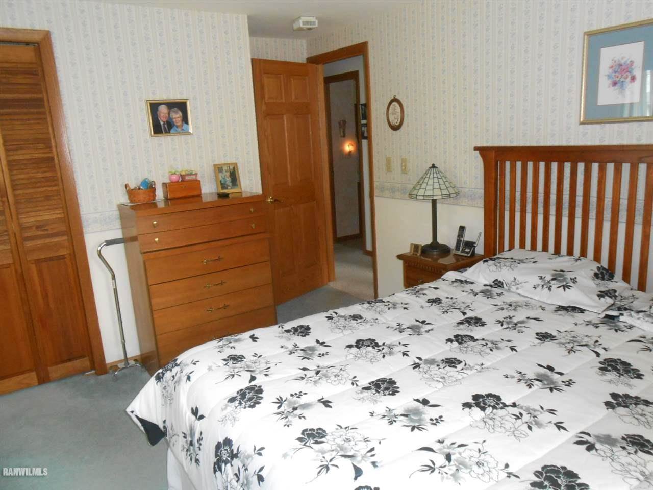 301 East Town Line Road Lena, IL 61048 - Photo 17 of 23 a bedroom with a bed and a dresser