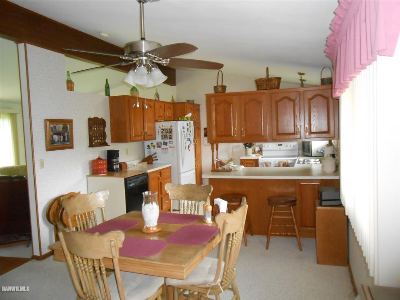 301 East Town Line Road Lena, IL 61048 - Photo 9 of 23 a dining room with stainless steel appliances kitchen island granite countertop furniture and a kitchen view