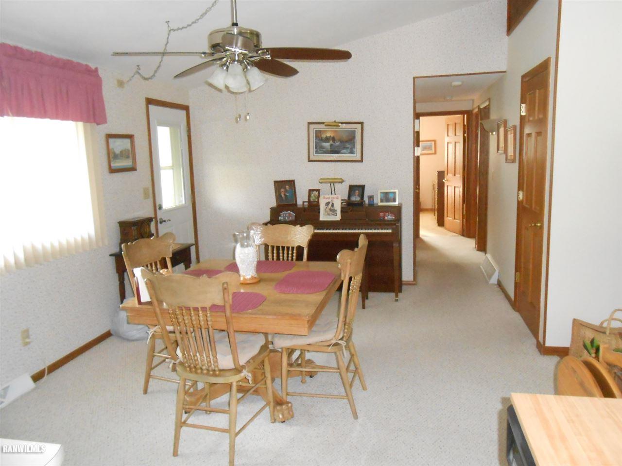 301 East Town Line Road Lena, IL 61048 - Photo 10 of 23 a view of a dining room with furniture and a chandelier