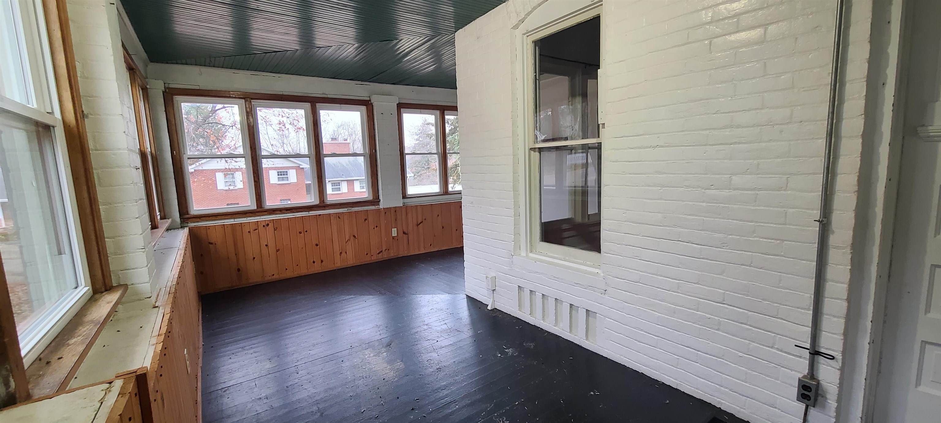 507 Lester Street Mount Carroll, IL 61053 - Photo 12 of 25 a view of an empty room with wooden floor and a window