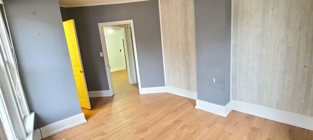 a view of an entryway with wooden floor