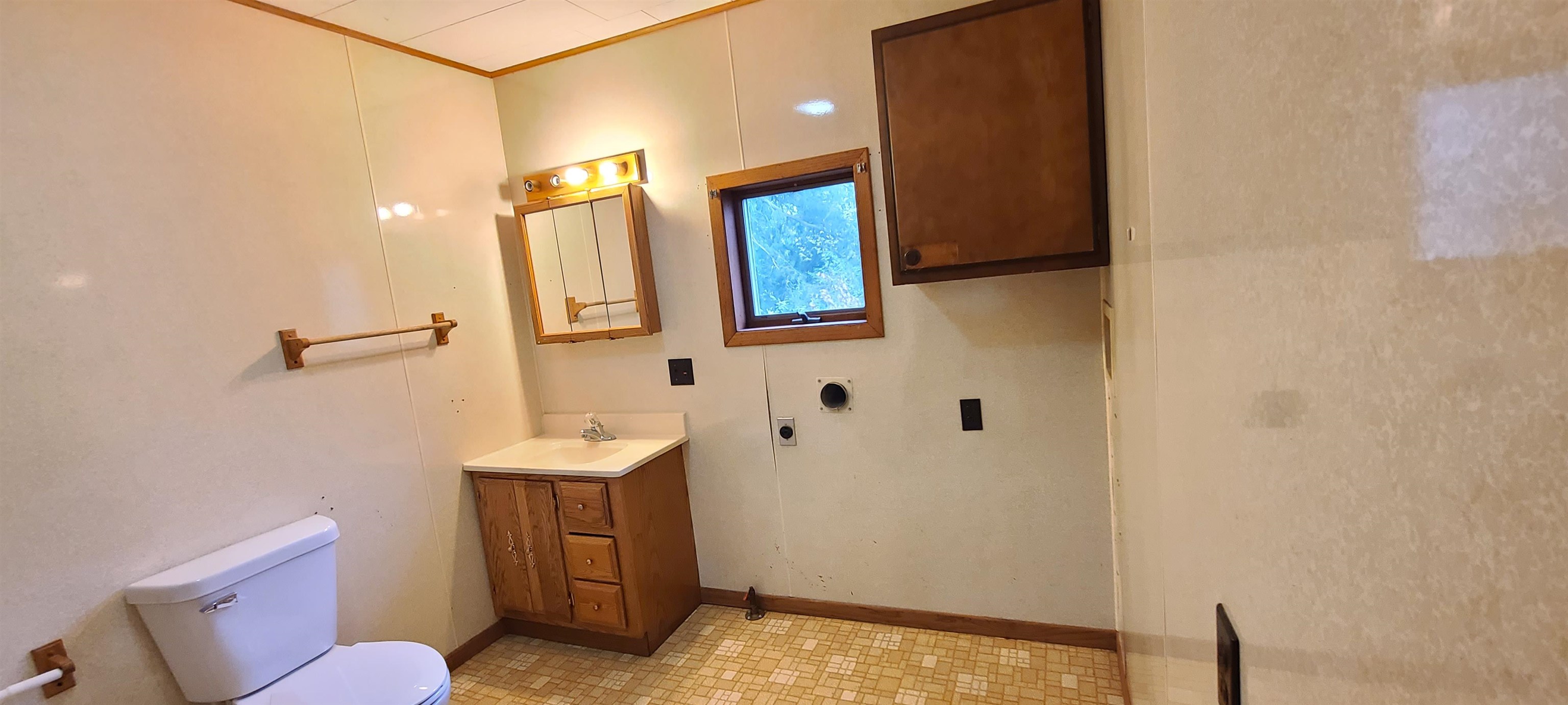 507 Lester Street Mount Carroll, IL 61053 - Photo 19 of 25 a bathroom with a sink a toilet a mirror and vanity